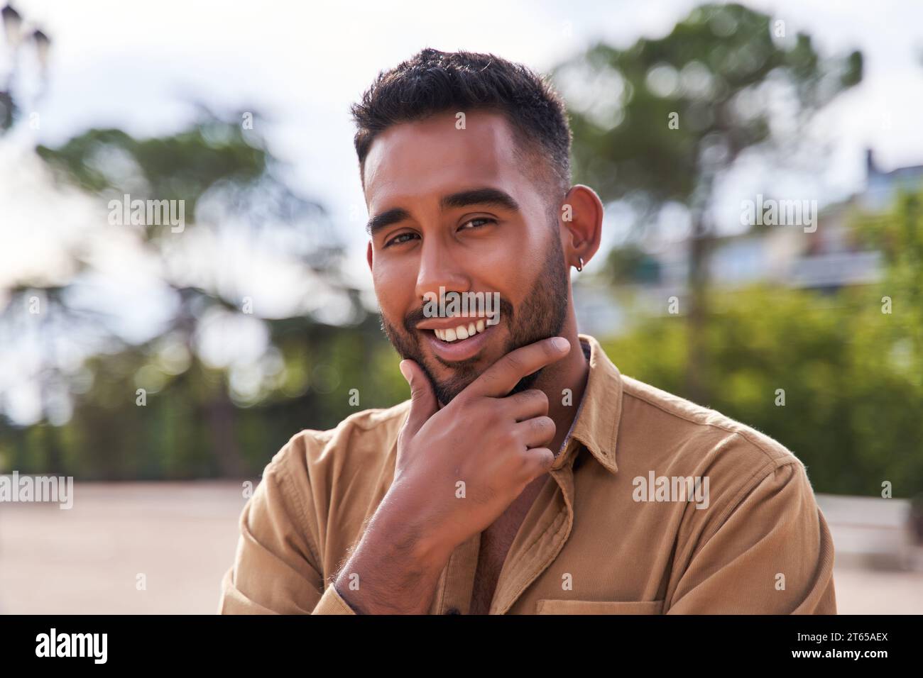 latino con barba e mento a mano Foto Stock