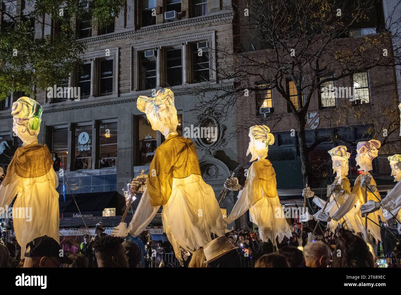 Una fila di statue allineate fianco a fianco in un ambiente urbano, con le loro caratteristiche distintive illuminate dalla calda luce del sole Foto Stock