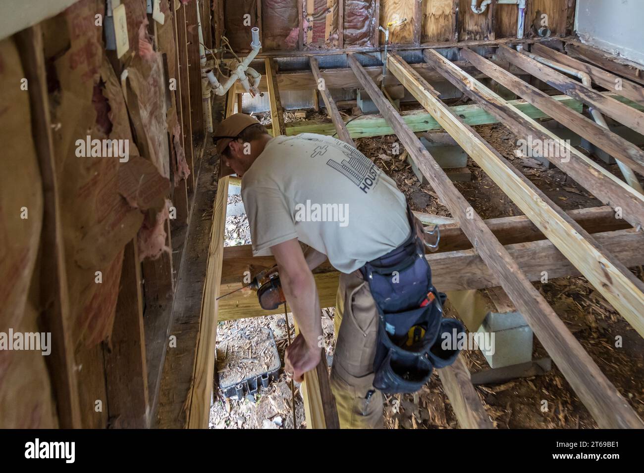 Membro di 8 giorni di Hope Faith based Charity Volunteer team che sostituisce il pavimento di una casa che è stata inondata a Houston, Texas Foto Stock