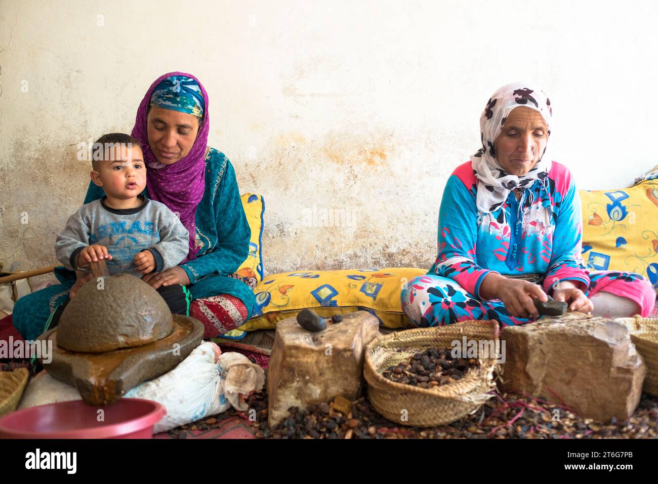 Due donne berbere in abbigliamento tradizionale estratto olio di Argan dai kernel dell'albero di Argan Foto Stock