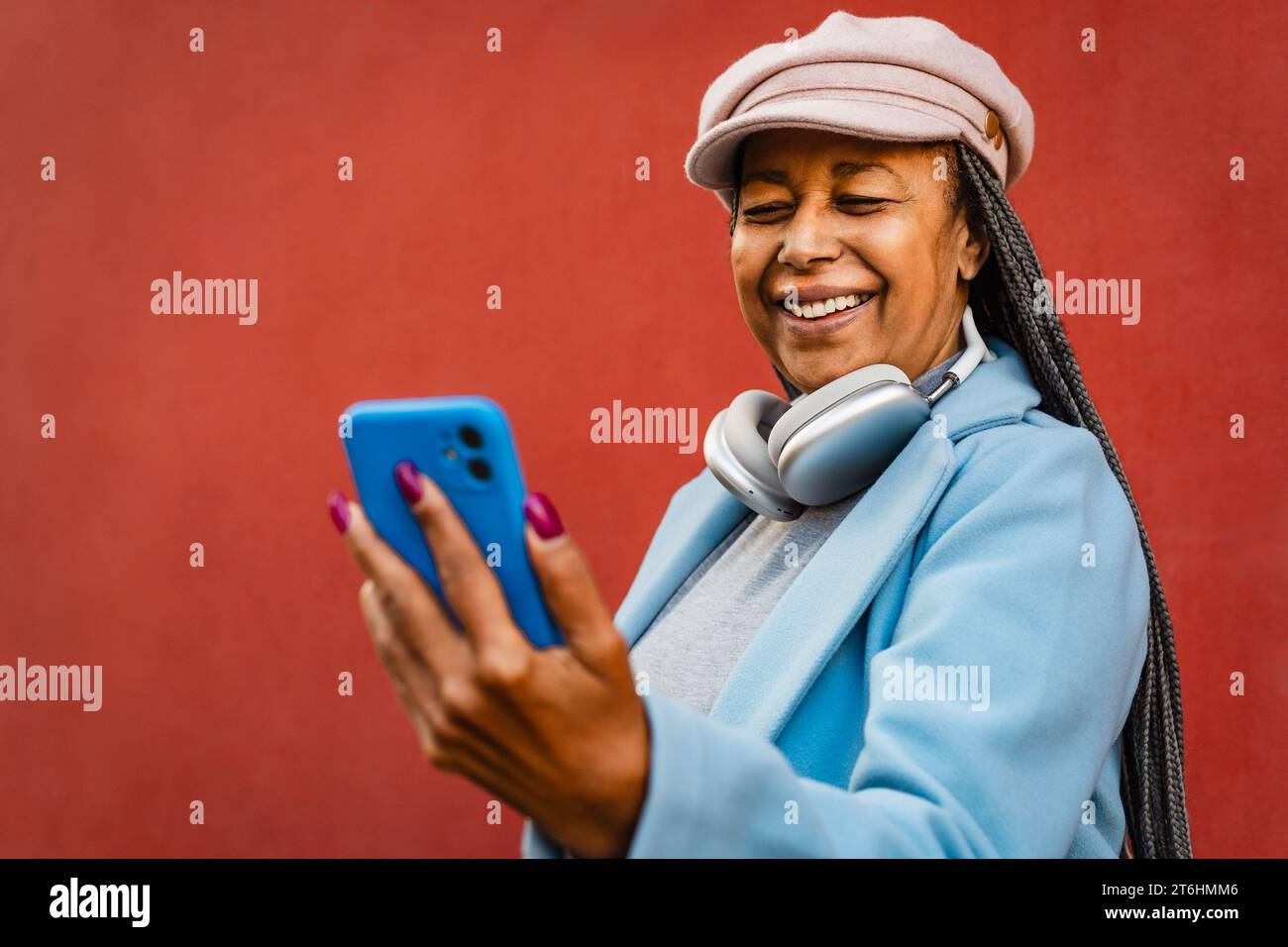 Donna africana anziana che si diverte con lo smartphone mobile all'aperto Foto Stock