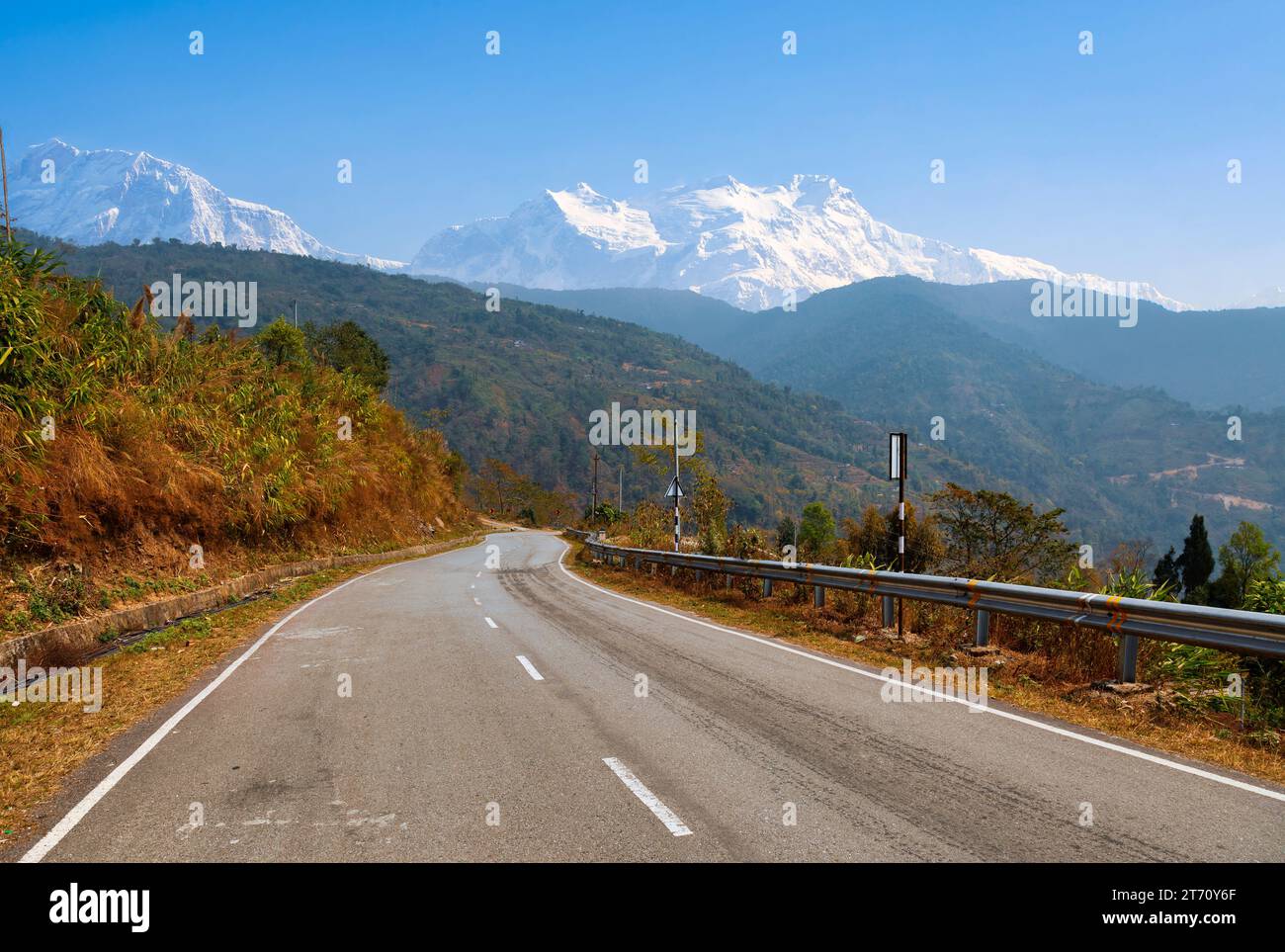 Strada autostradale di montagna con paesaggio himalayano panoramico e vista della catena montuosa dell'Himalaya Kanchenjunga sulla strada per Tinchuley, Darjeeling, India. Foto Stock