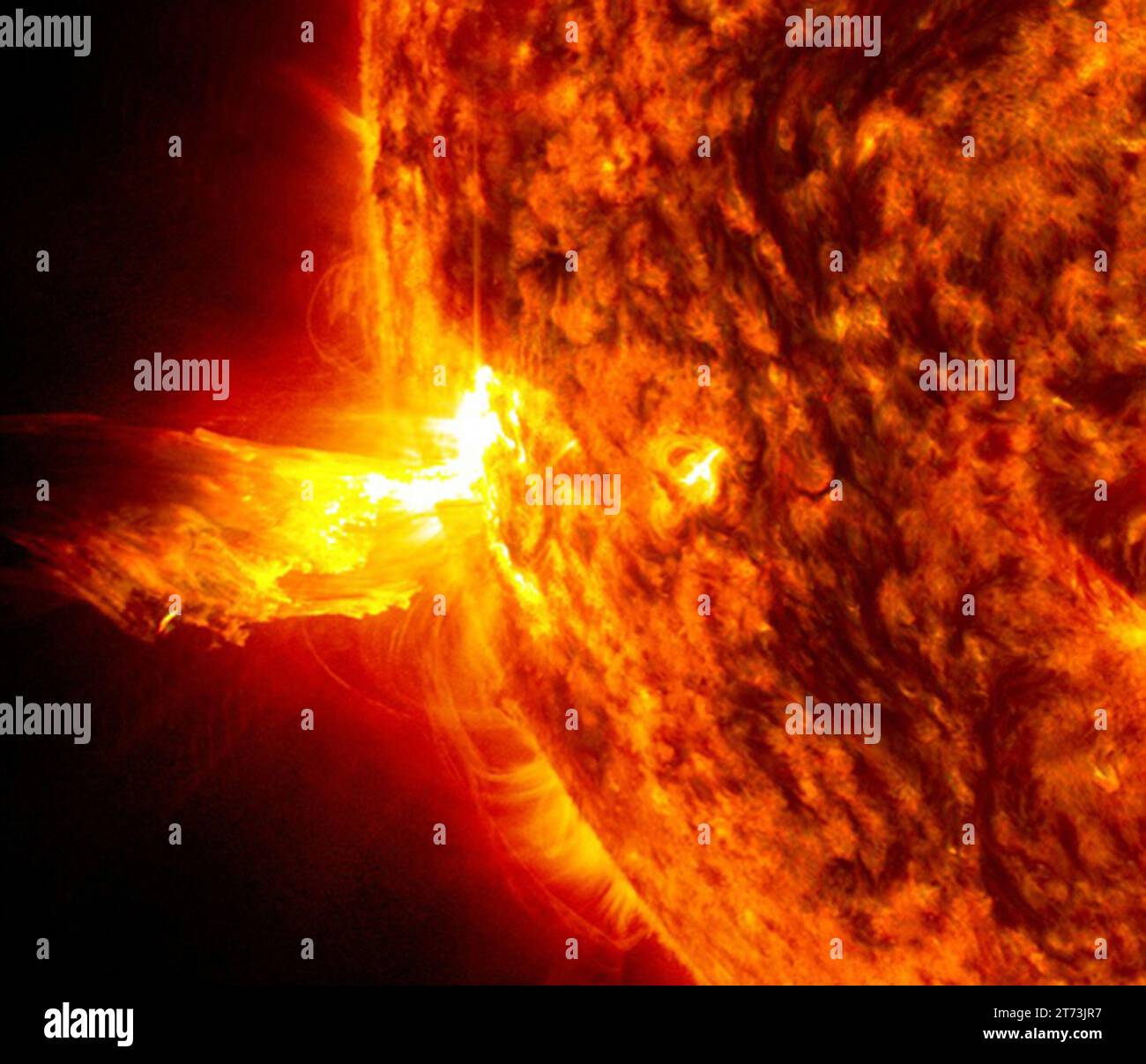 Questa immagine del 20 giugno 2013, alle 23:15 EDT mostra la luce brillante di una luce solare sul lato sinistro del sole e un'eruzione di materiale solare Foto Stock