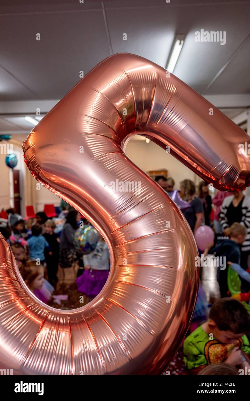 Numero 5, palloncino con elio d'oro ad una festa per il quinto compleanno dei bambini Foto Stock