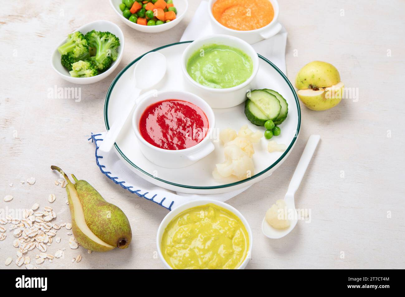 Alimenti per bambini. Ciotole con purea di frutta vegetale, verde, arancione, giallo - broccoli, carote, banana, mela. Foto Stock