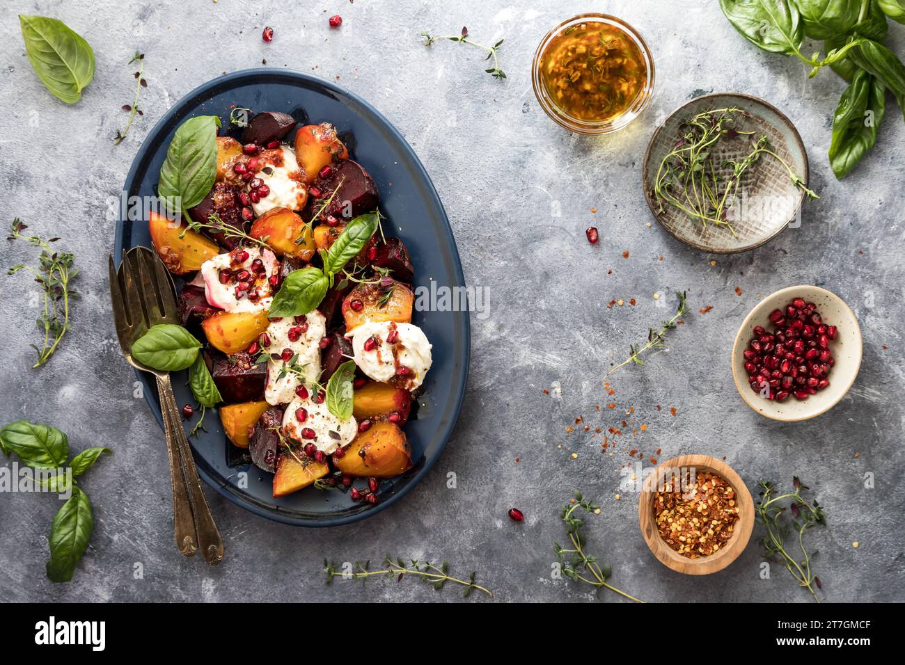 Un piatto di barbabietole arrostite condite con melograno, erbe e burrata. Foto Stock