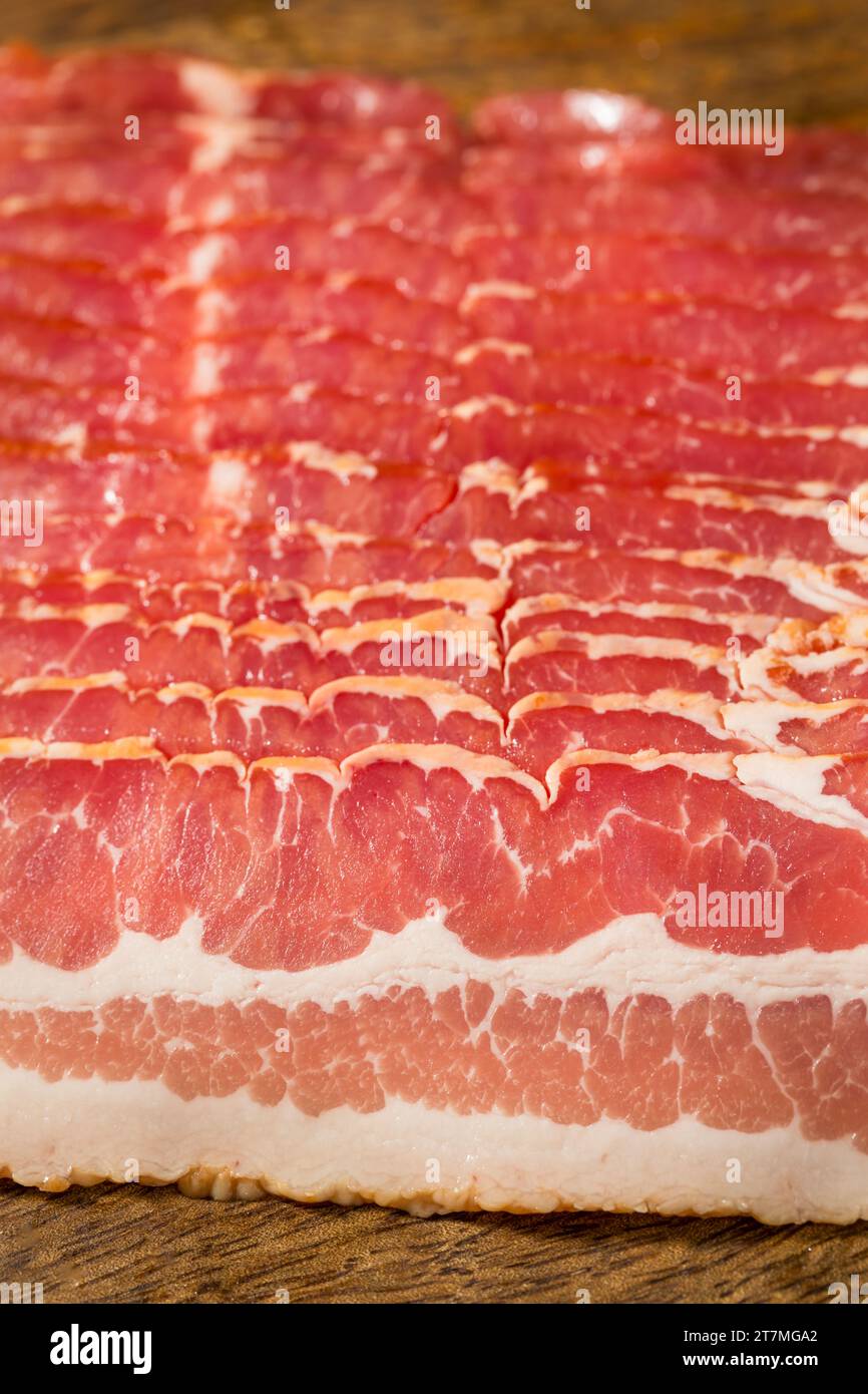 Red Organic Raw Bacon Cut into Slices Foto Stock