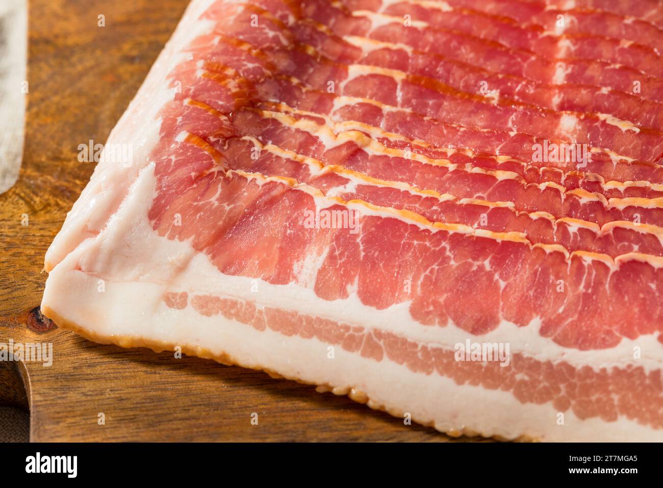 Red Organic Raw Bacon Cut into Slices Foto Stock
