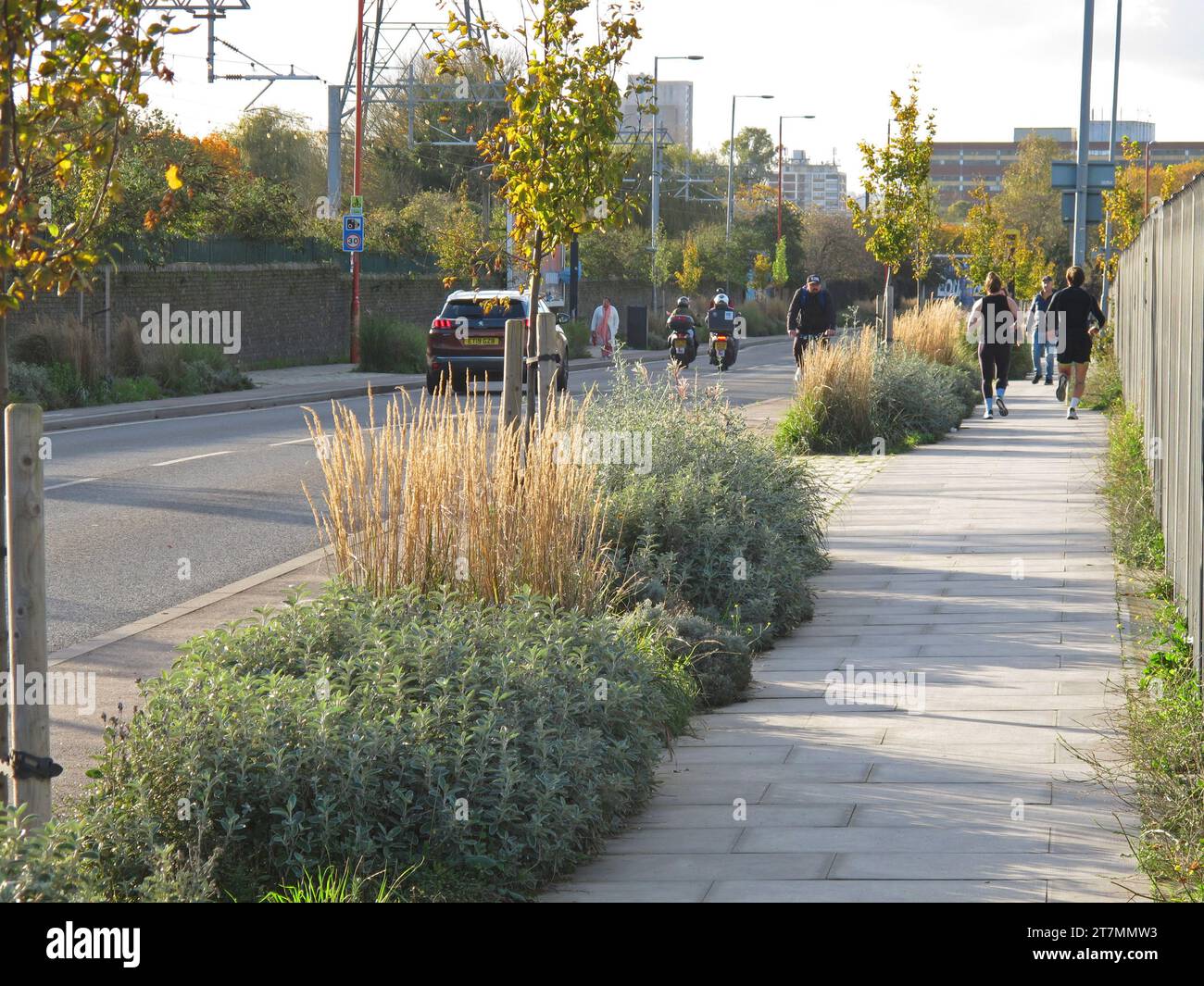 L'impianto di nuova installazione separa il marciapiede da una nuova pista ciclabile su Forest Road, Tottenham, Londra, Regno Unito. Mostra ciclisti e jogger. Foto Stock