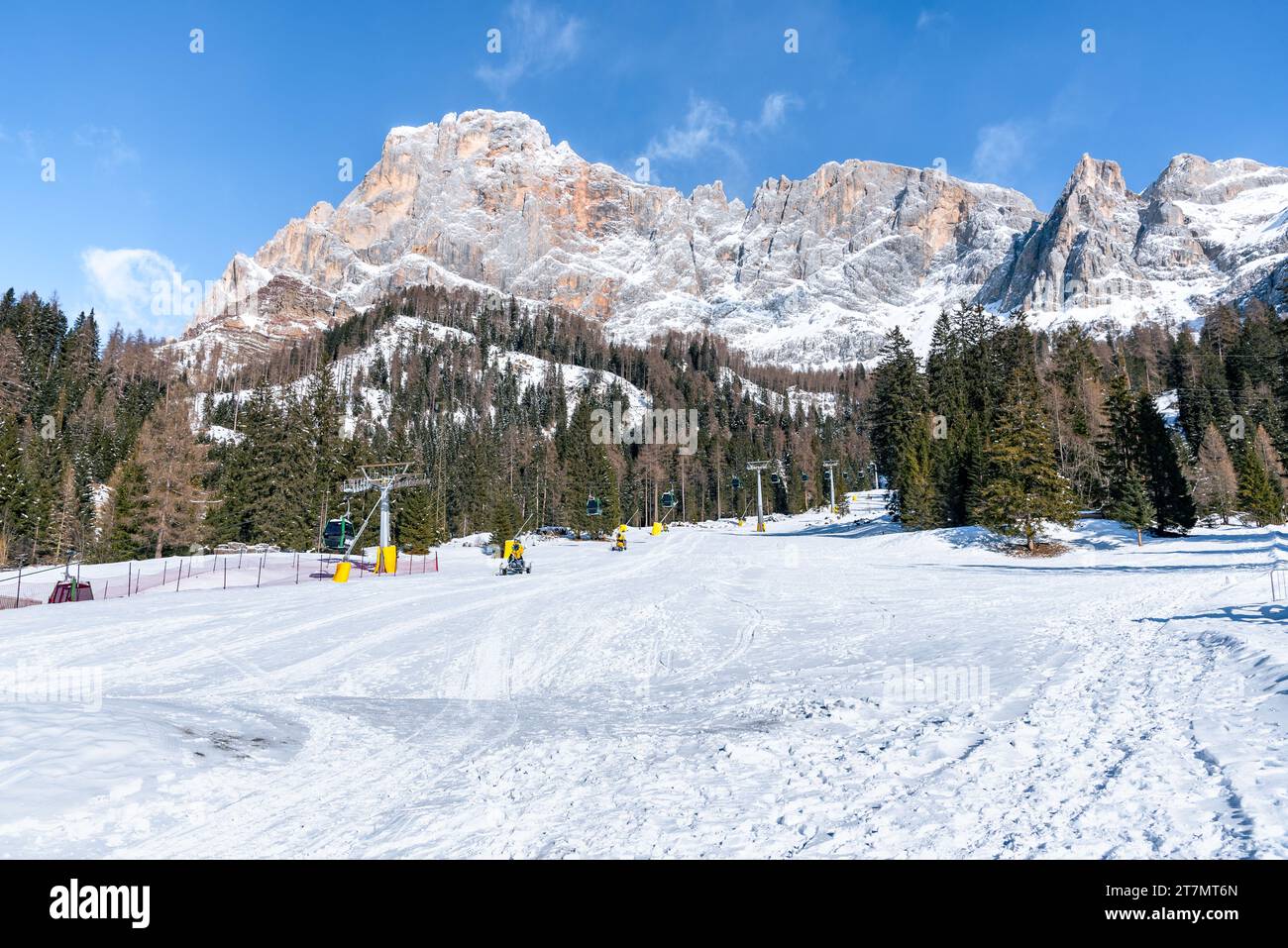 Funivia in una zona sciistica ai piedi delle torreggianti cime rocciose innevate delle Alpi in inverno Foto Stock
