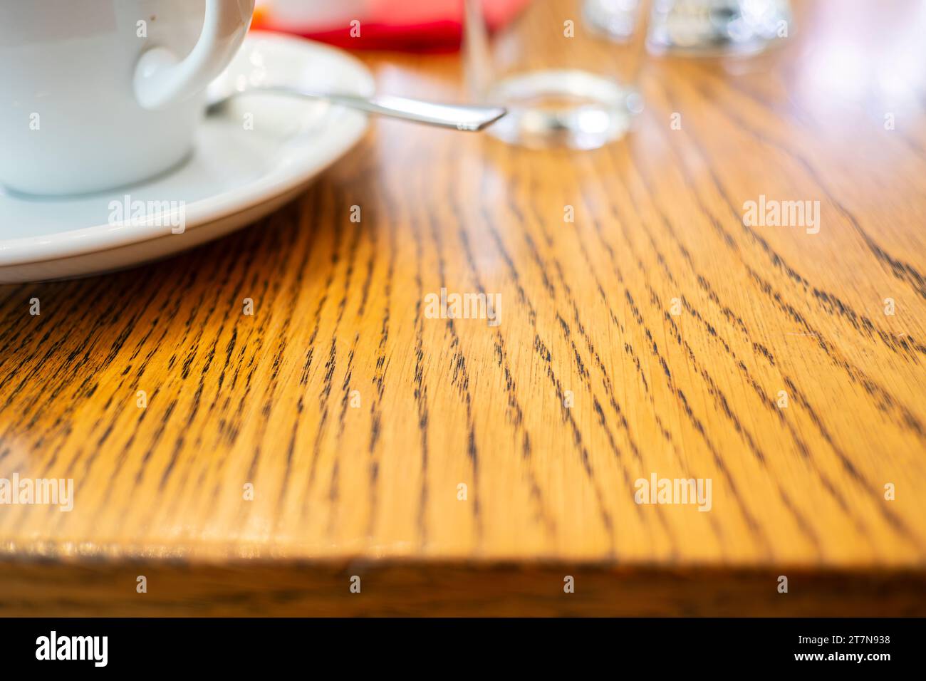 Tazza di caffè su un piattino su un tavolo di legno in un ambiente di catering. Foto Stock