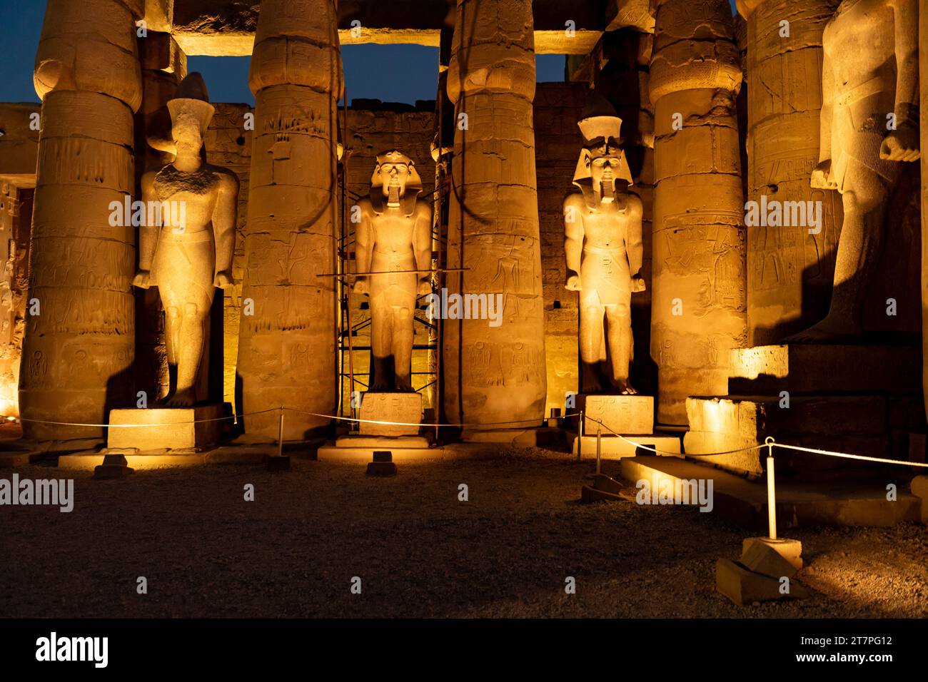 Vista notturna delle statue, delle colonne e dei geroglifici del tesoro archeologico e della destinazione turistica del tempio di Luxor illuminata di notte Foto Stock