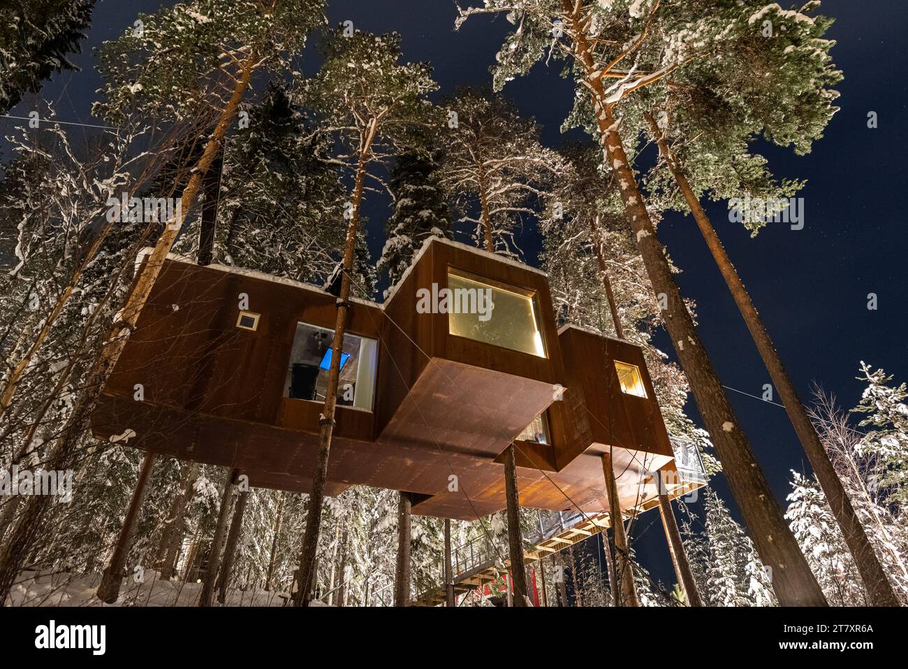 Vista notturna di un cottage sospeso in legno nella foresta ricoperta di neve, Harads, Lapponia, Svezia, Scandinavia, Europa Foto Stock
