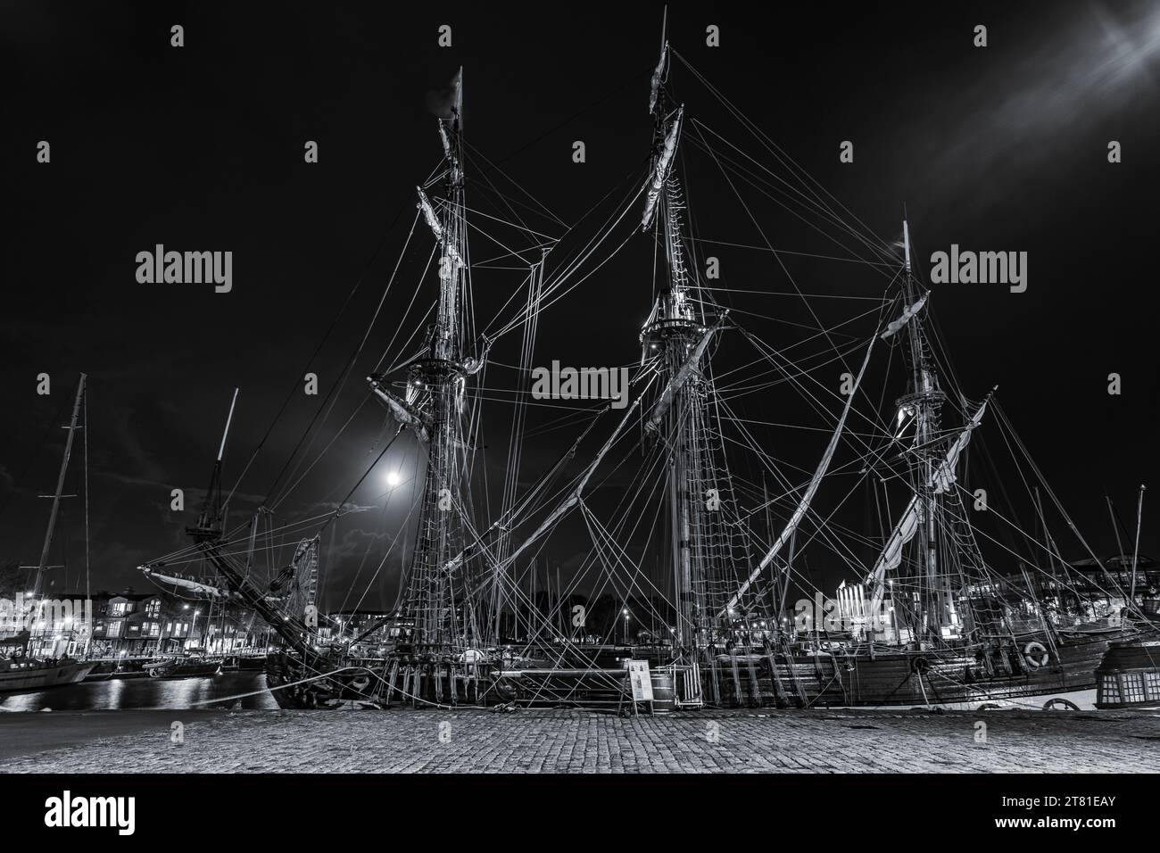 Vecchie navi a vela in legno ormeggiate nel porto di la Rochelle vicino al quartiere di gabut. ripresa notturna in bianco e nero Foto Stock