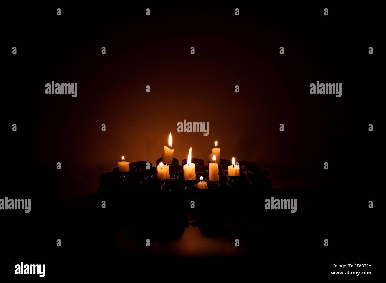 Le candele incendiate si trovano in involucri di lanciagranate sprecati al buio, tristezza per coloro che sono stati uccisi nella guerra in Ucraina Foto Stock