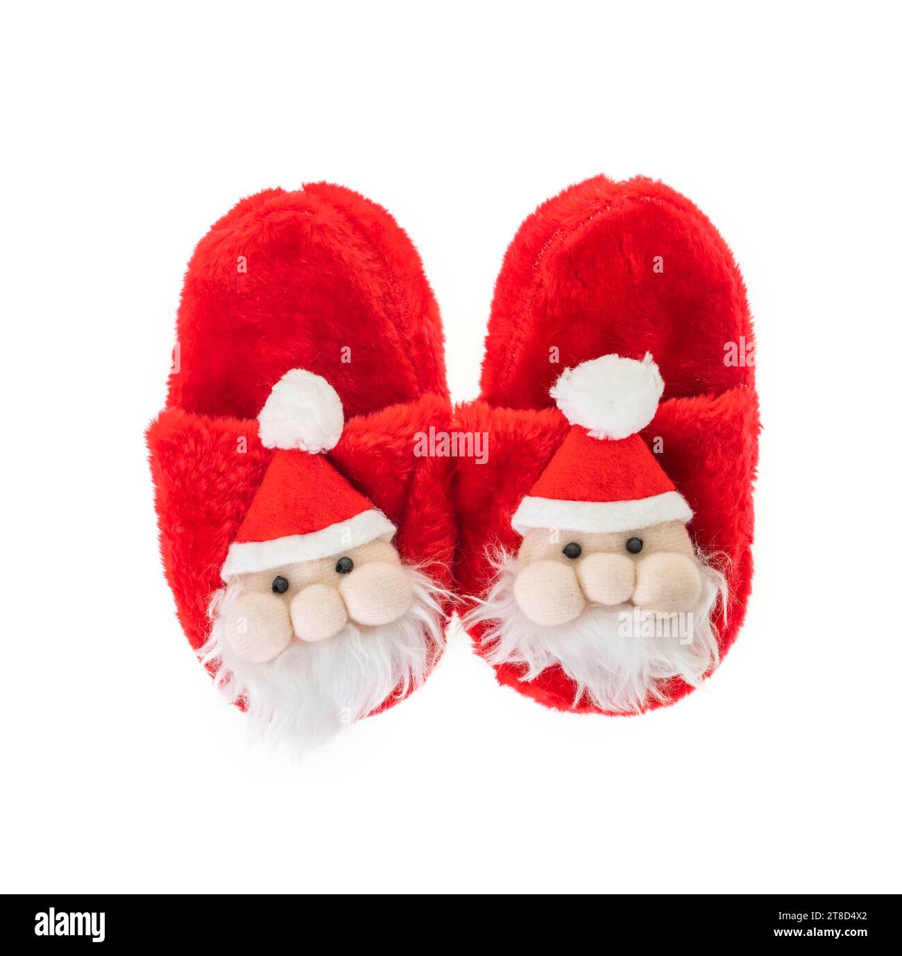 Pantofole per il Capodanno per bambini sotto forma di Babbo Natale. Accessori e regali di Natale tradizionali per le feste. Foto Stock