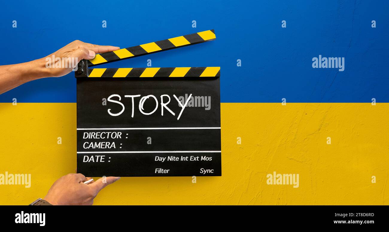 Le mani della troupe cinematografica dell'industria cinematografica con una lastra nera o un clapperboard scrivono la parola "storia" Foto Stock