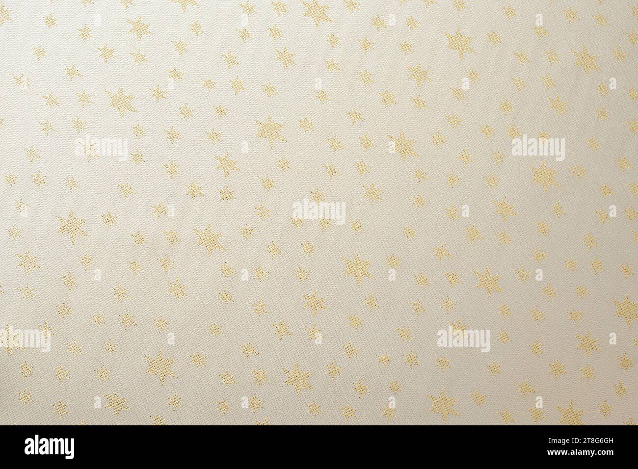 tovaglia beige con stelle dorate, texture ravvicinata Foto Stock