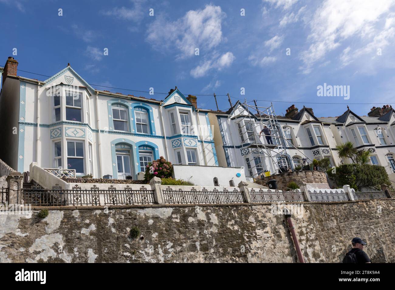 Città di Porthleven in Cornovaglia Inghilterra, case a due piani terrazzate in colori pastello si affacciano sul porto e la costa, Cornovaglia, Inghilterra, Regno Unito, 2023 Foto Stock