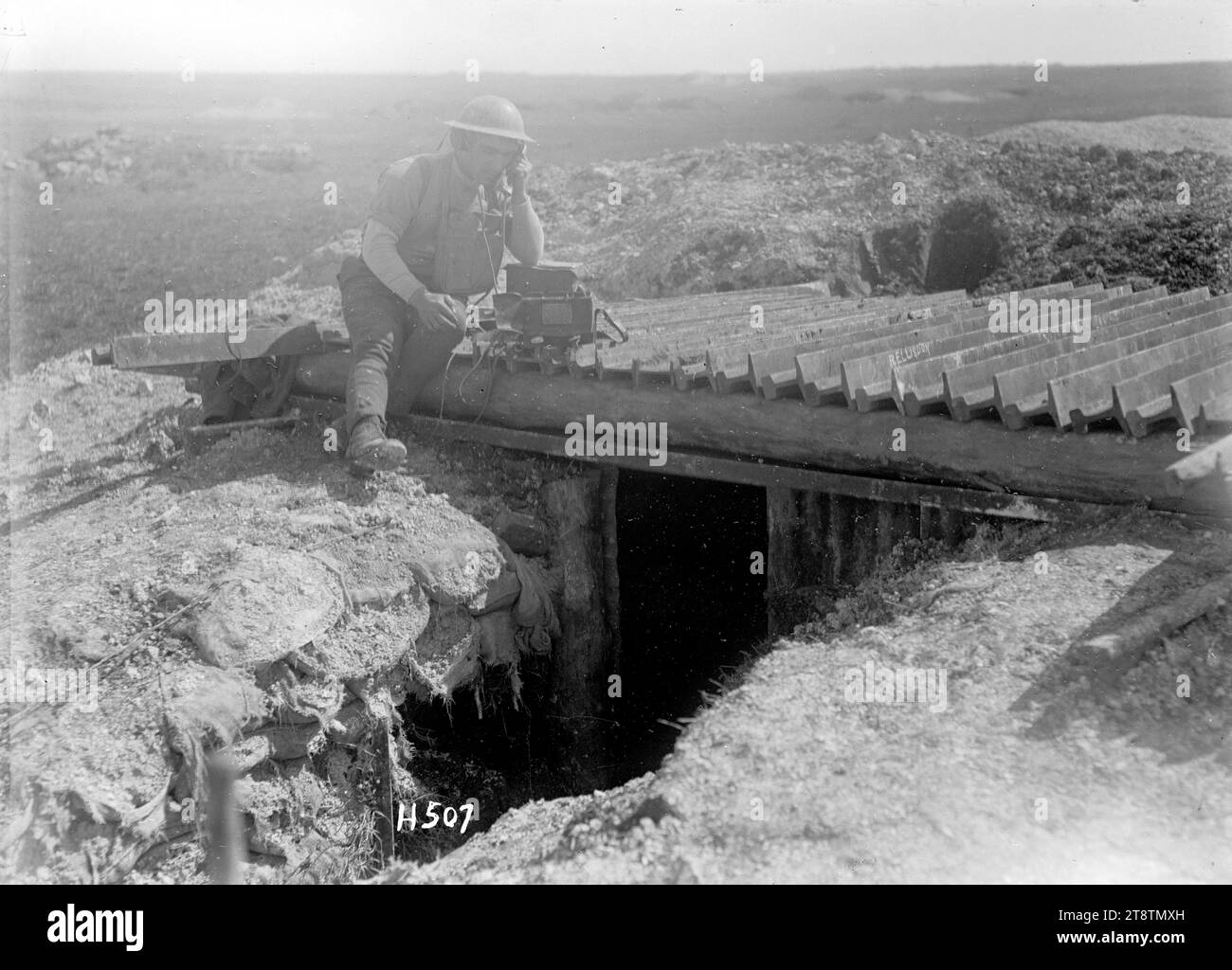 Un segnalatore lascia il suo dugout sulla somme per lavorare al sole, Un segnalatore neozelandese seduto sul tetto del suo dugout usando un telefono da campo. Foto scattata nei pressi di Colincamps il 15 aprile 1918 Foto Stock