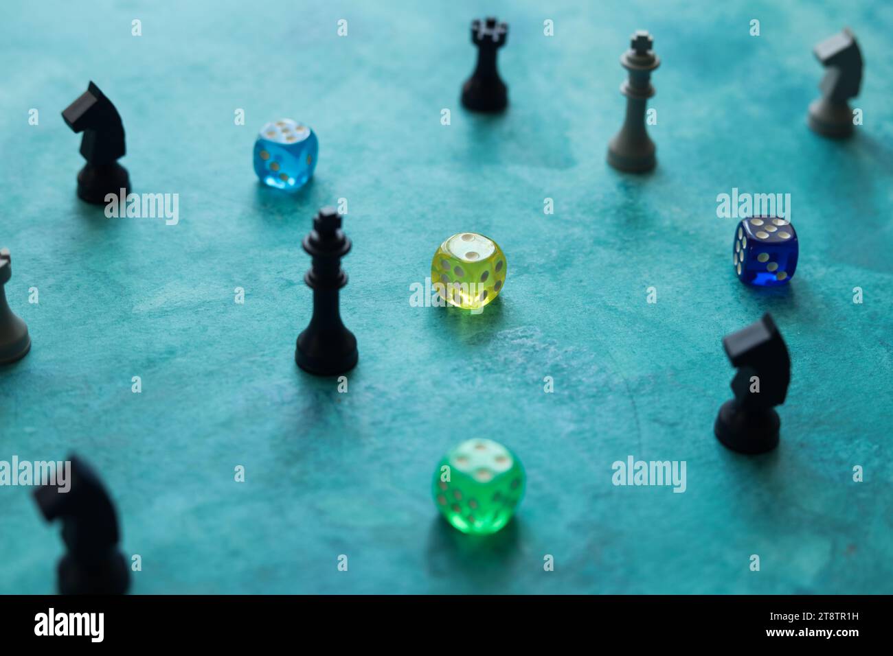 pezzi da scacchi e dadi colorati su uno sfondo blu acquerello Foto Stock