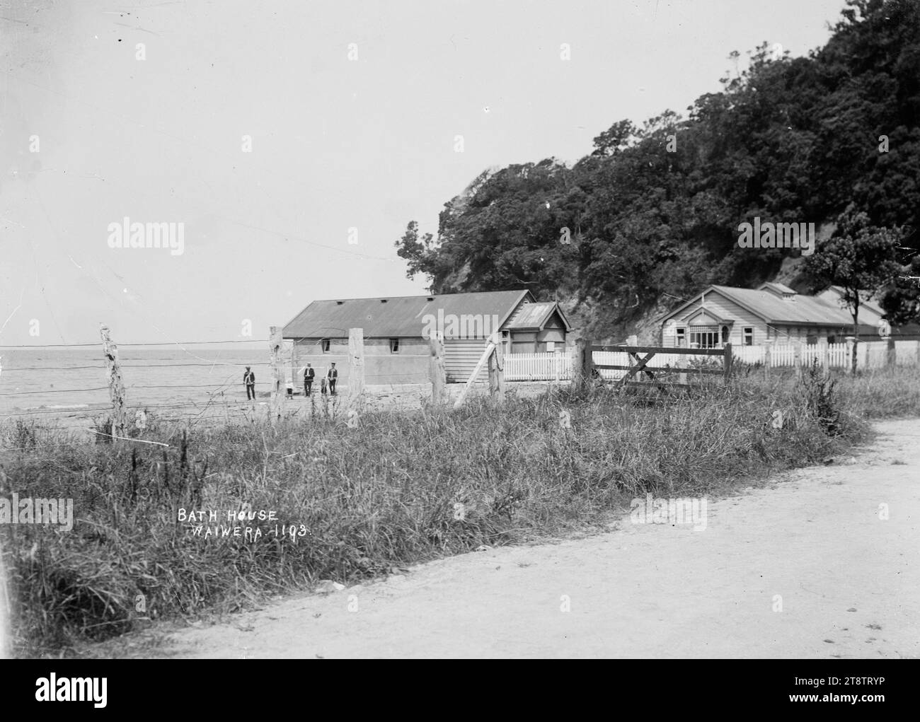 Bagni presso l'Hot Springs Hotel, Waiwera, Vista dei bagni sulla spiaggia e vicino all'Hot Springs Hotel a Waiwera. Preso dalla strada che guarda a sud-est verso la spiaggia, con il mare sullo sfondo. all'inizio degli anni '1900 Foto Stock