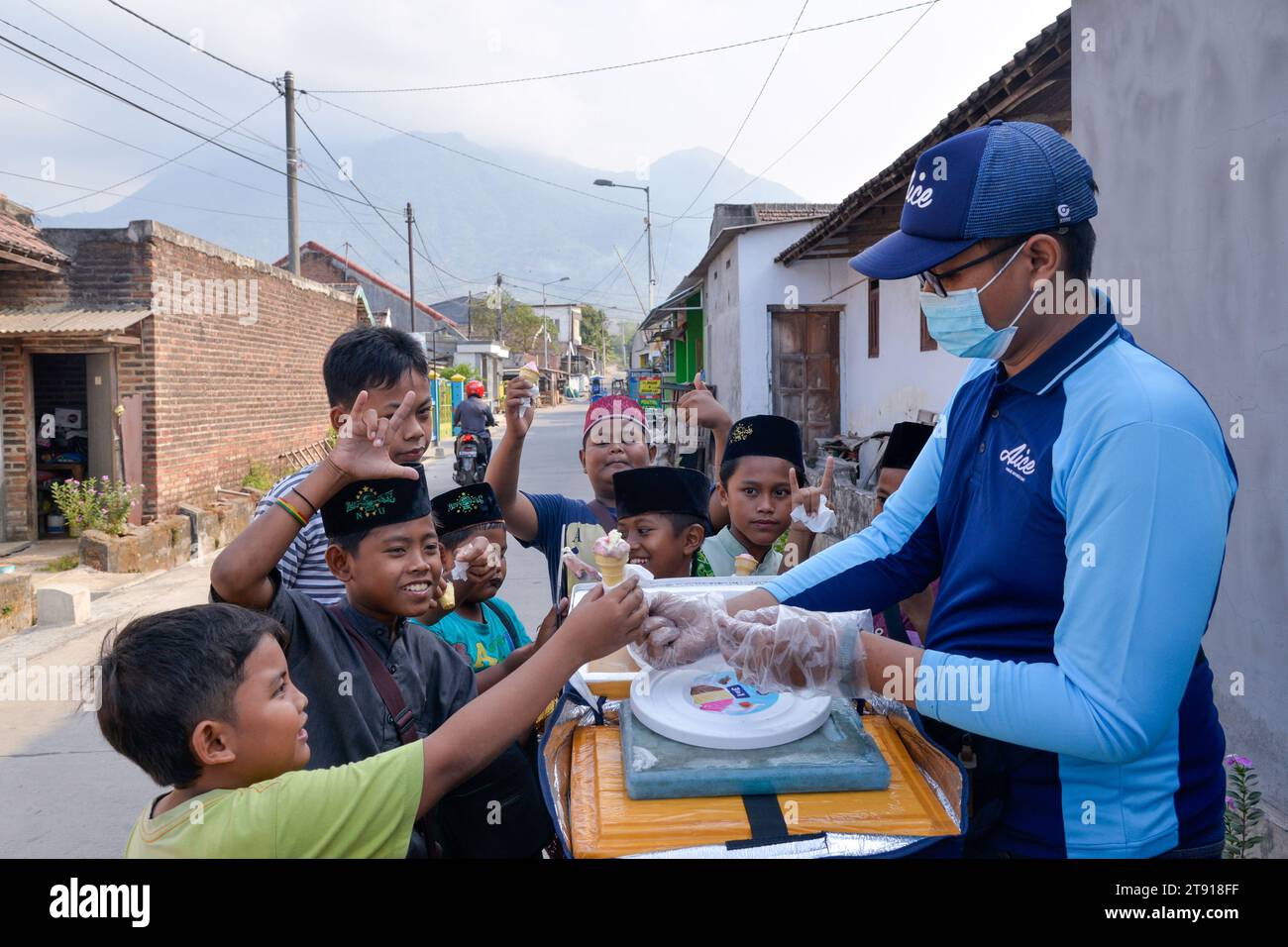 Giacarta, Indonesia. 14 settembre 2023. I bambini acquistano il gelato AICE da Yusuf Afat's AICE, vendita di gelati, bicicletta a Mojokerto, Giava Orientale, Indonesia, 14 settembre 2023. Vivendo ai tropici, il popolo indonesiano soffre di maltempo. AICE, una famosa marca di gelati del paese, li raffredda e porta gioia. DA NON PERDERE: Gelato AICE, cuore dolce per gli indonesiani credito: Xu Qin/Xinhua/Alamy Live News Foto Stock