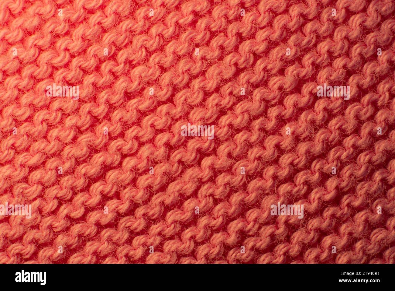 Consistenza del tessuto di un maglione rosso. Foto Stock