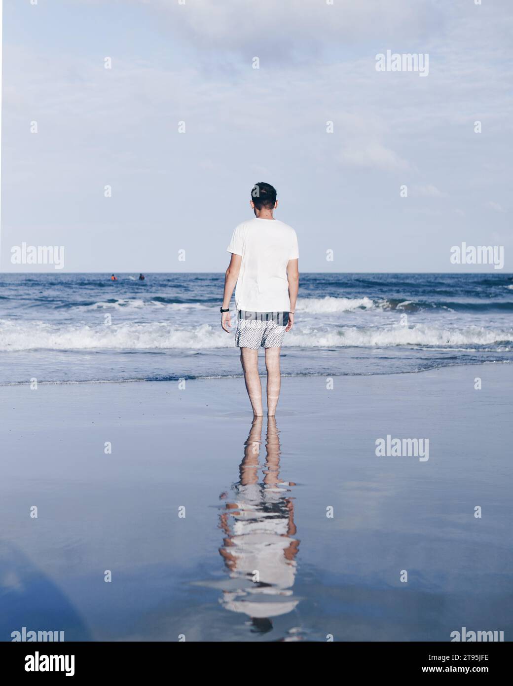 ritratto della persona che cammina sulla spiaggia e guarda l'orizzonte Foto Stock