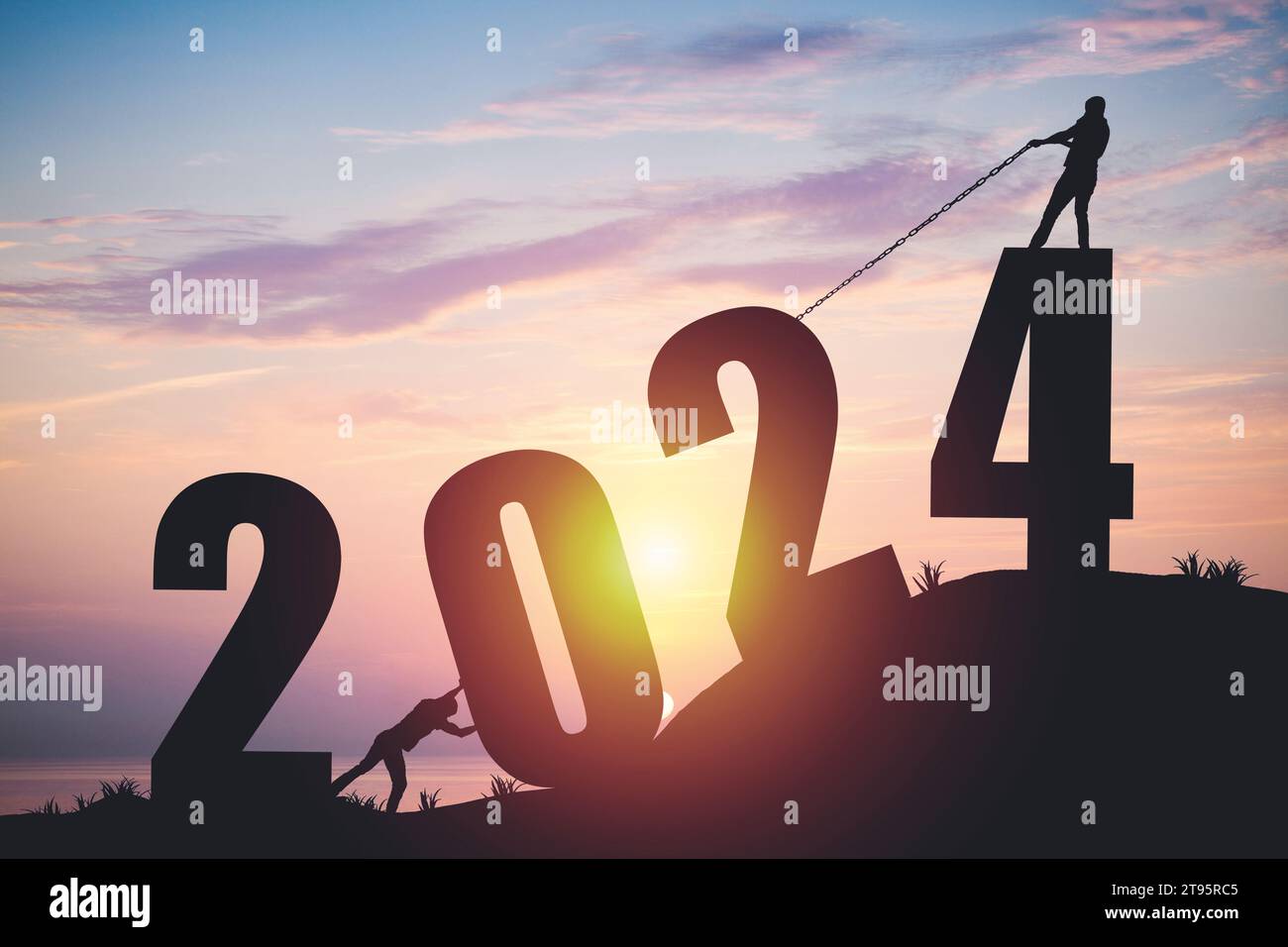 Silhouette da uomo che spinge e e tira l'anno 2024 su uno sfondo dorato all'alba Foto Stock