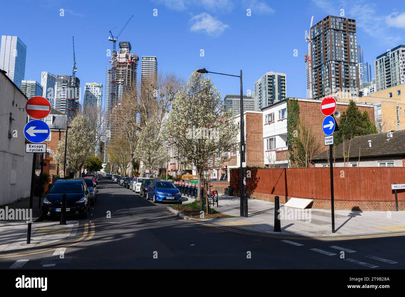 La casa sociale di Alpha Grove si trova in contrasto con i torreggianti grattacieli di Canary Wharf in costruzione sullo sfondo. Alpha Grove, Foto Stock