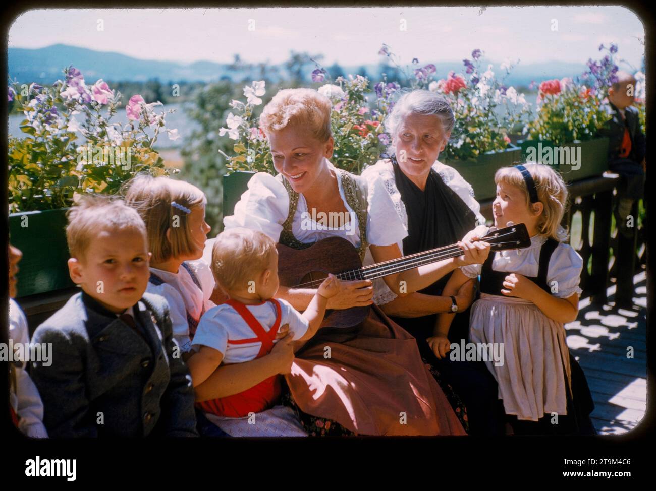 L'attrice Mary Martin (centro sinistro), presto per esibirsi a Broadway nel musical Rodgers & Hammerstein, "tutti insieme appassionatamente", canta con la Real Maria von Trapp (centro destro) e alcuni dei suoi nipoti, Stowe, Vermont, agosto 1959. (Foto di Toni Frissell) Foto Stock