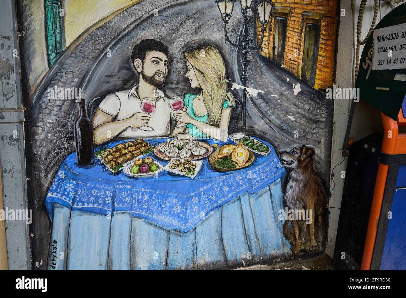 Grafitto, junges Paar beim Essen, typisch georgische Speisen, Bankomat, Stadtteil Awlabari, armenisches Viertel, Avlabari, Tiflis, Georgien Foto Stock