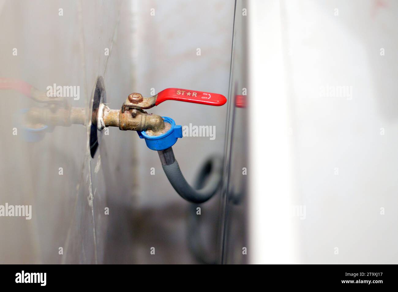 Cairo, Egitto, 9 ottobre 2023: Rubinetto per lavatrice Star con tubo flessibile per l'acqua per l'alimentazione dell'acqua alla valvola di ingresso dell'acqua, manutenzione ed elettrodomestici Foto Stock