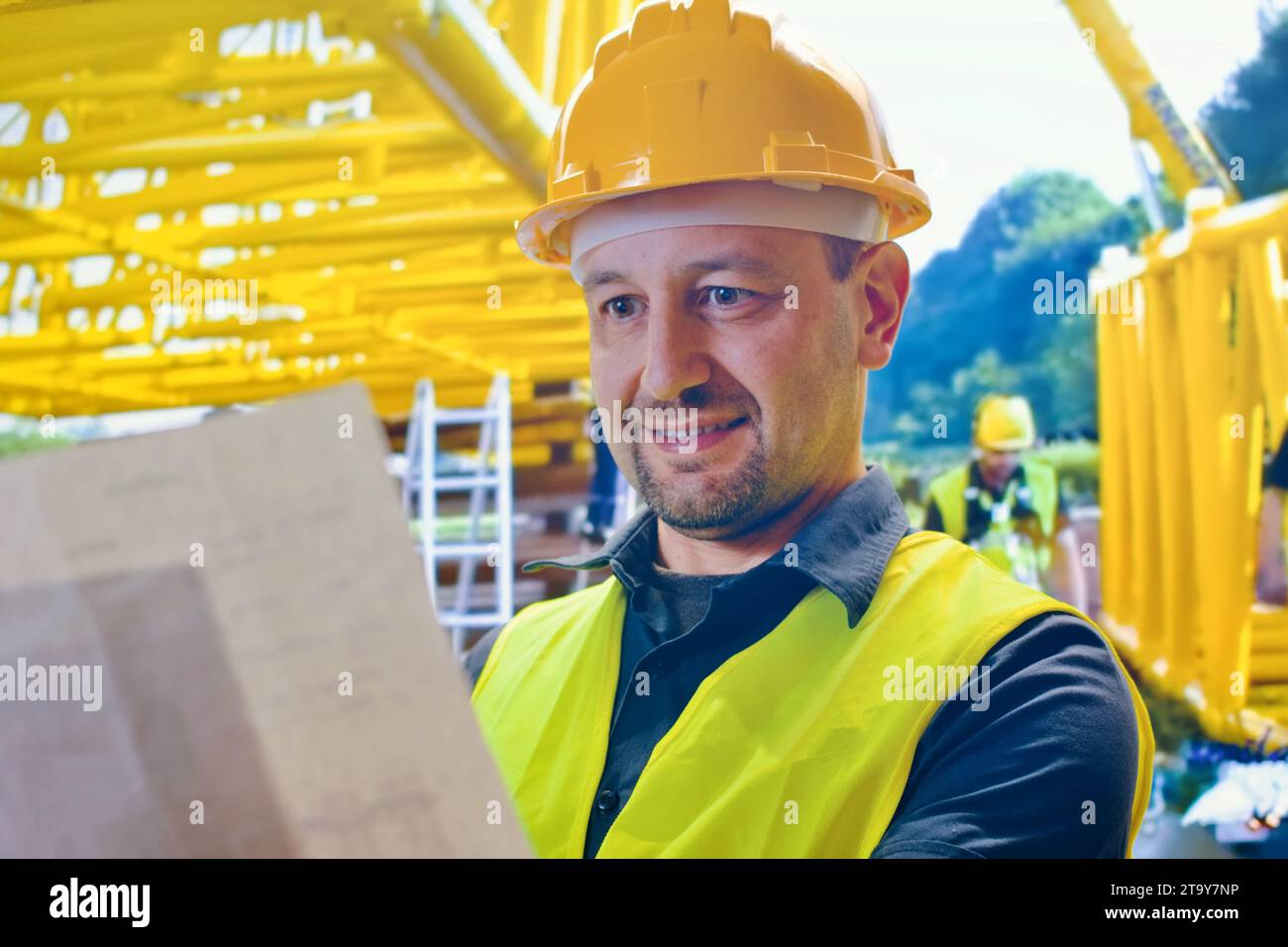 Ritratto di giovane è ingegnere indossare casco sorriso soddisfatto in cantiere, architetto o appaltatore in piedi e le braccia incrociate con con con Foto Stock