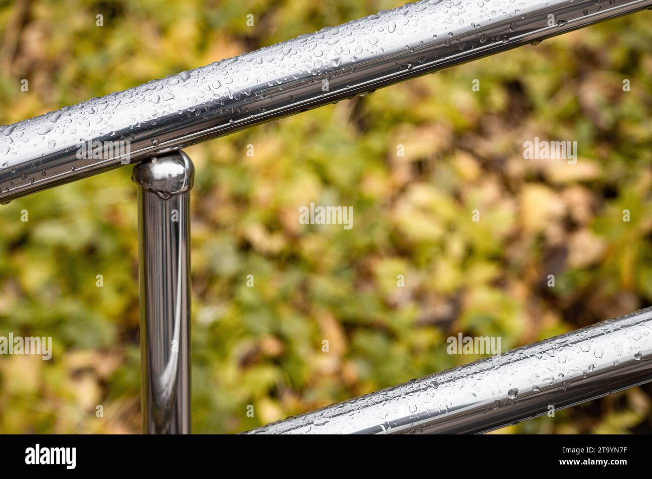 corrimano in metallo con gocce di pioggia, tiro con profondità di campo ridotta. ringhiere in metallo Foto Stock