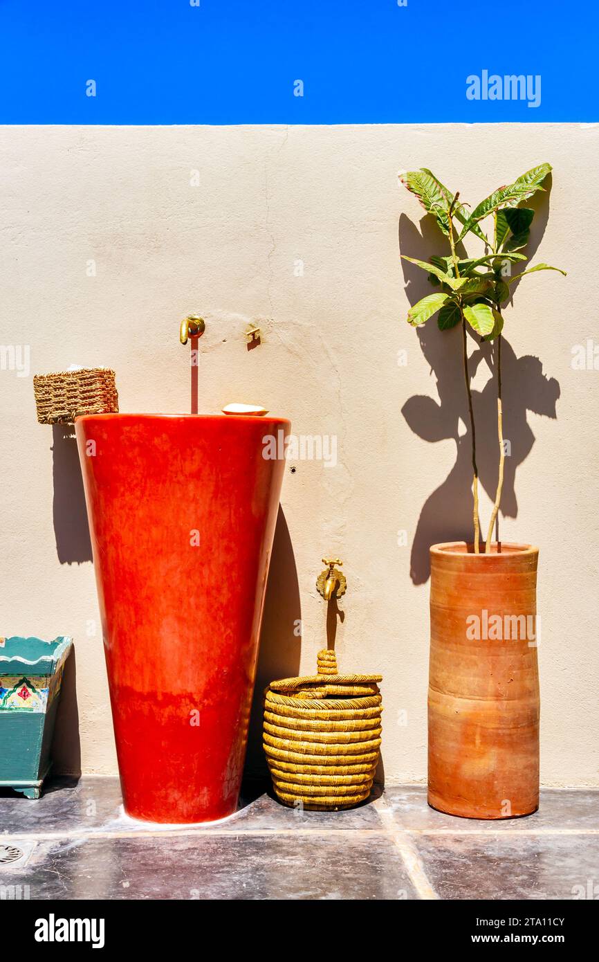 Dissipatore di deco e piante contro un muro in un paese mediterraneo. Foto Stock