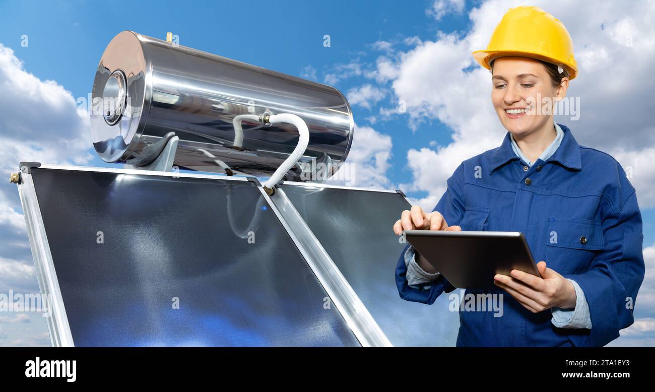 Lavoratrice donna con tablet digitale accanto a un collettore solare Foto Stock