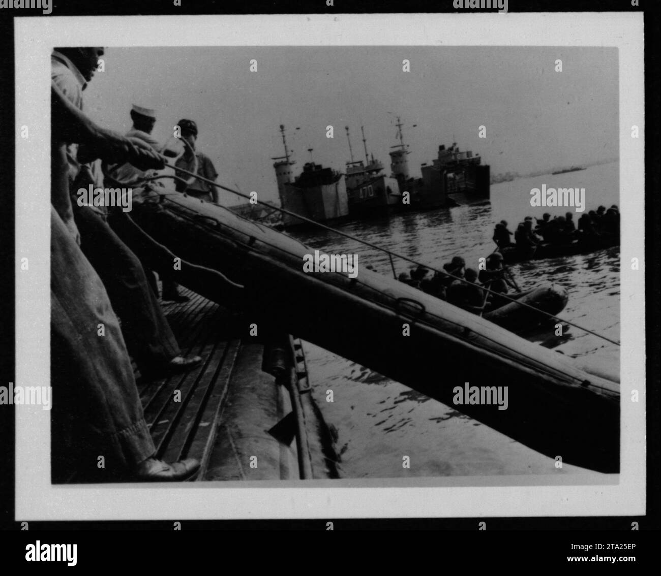 In questa immagine raffigurante le attività militari americane durante la guerra del Vietnam si vedono varie navi, tra cui pescherecci, imbarcazioni da sbarco e la USS Tripoli LPH-10. Queste imbarcazioni svolsero un ruolo cruciale nelle operazioni marittime e nel trasporto di personale e rifornimenti durante il conflitto. Foto Stock