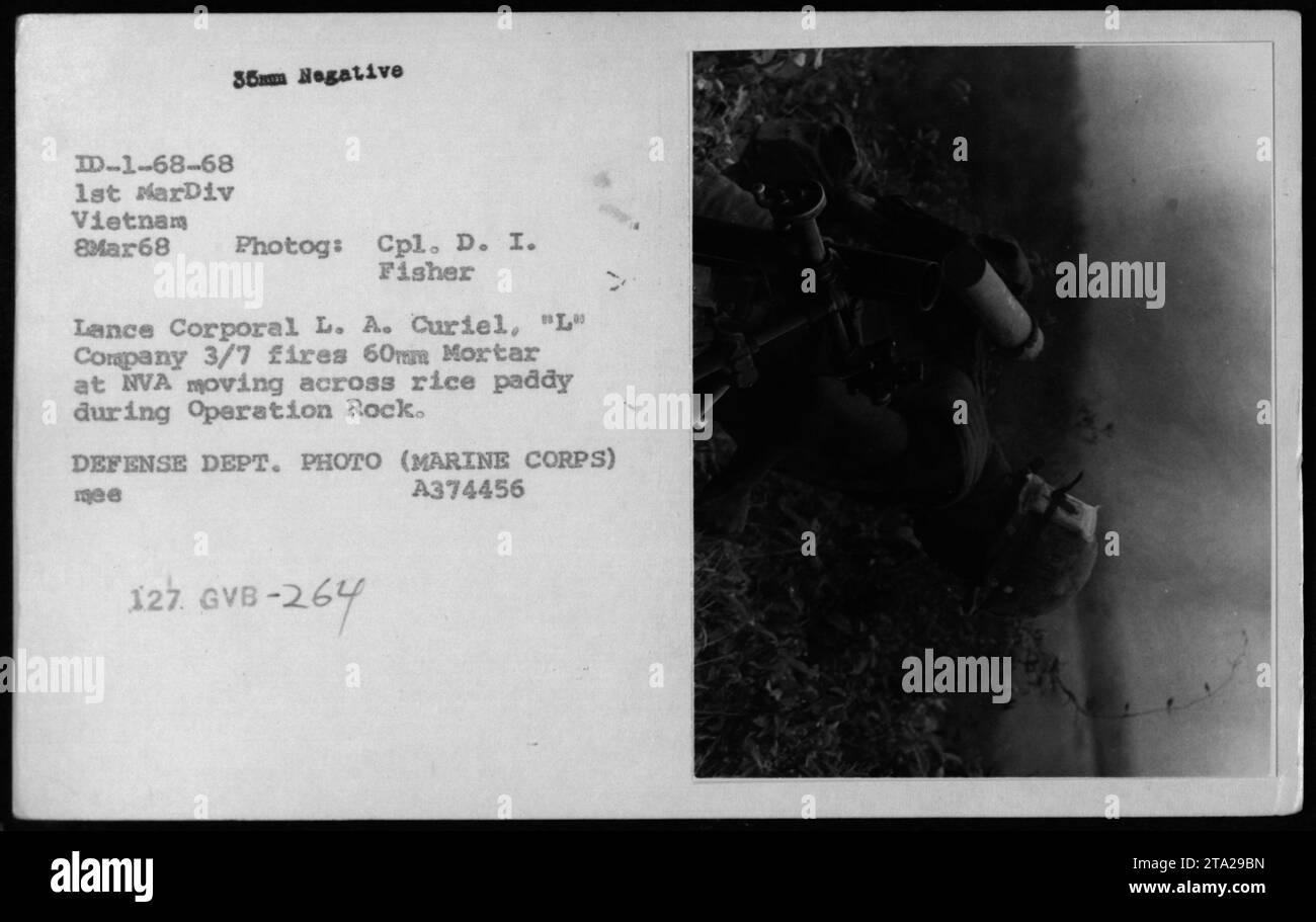 L'8 marzo 1968, il caporale Lance L.A. Curiel della compagnia L, 3/7, 1st Marine Division, sparò un mortaio da 60 mm alle truppe dell'esercito nordvietnamita attraversando una risaia durante l'operazione Rock in Vietnam. La fotografia e' stata scattata dal Cpl. D.I. Fisher. Foto Stock
