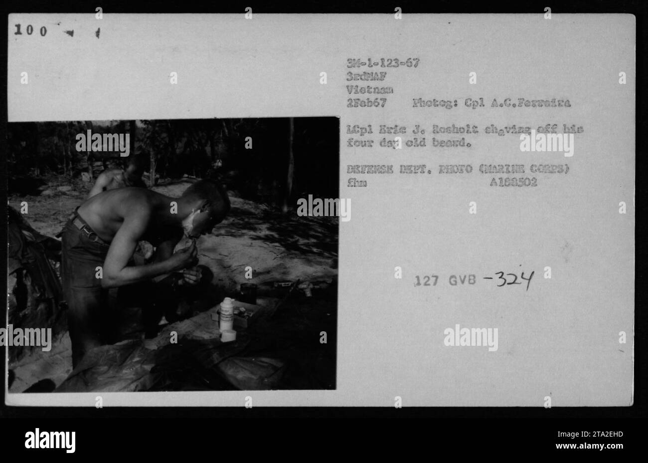 Il 2 febbraio 1967, il LCpl Eric J. Rosholt si rasa la barba di quattro giorni nella sezione docce, riflettendo la cura personale e l'igiene dei Marines durante la guerra del Vietnam. Foto Stock