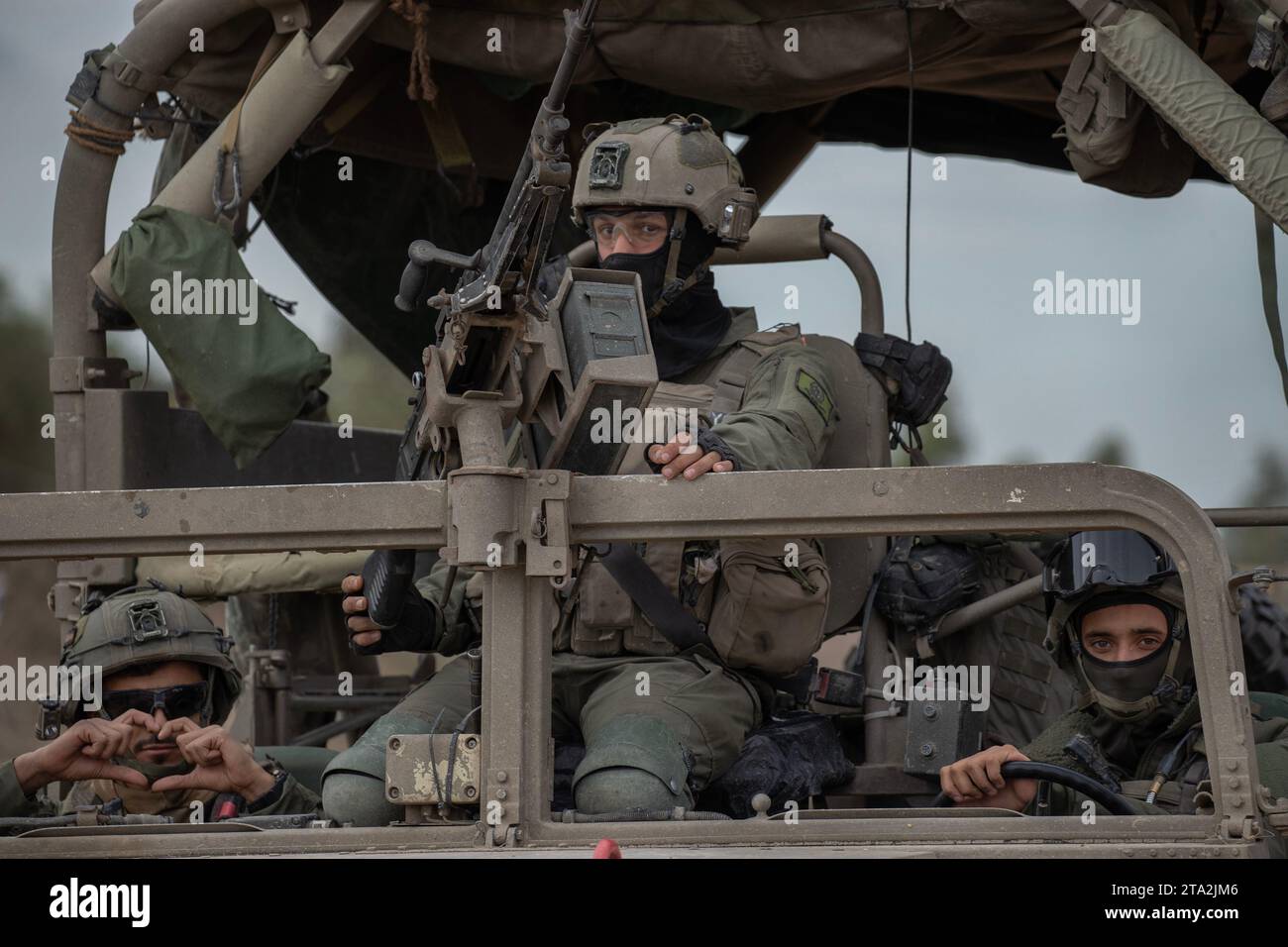 Israele meridionale, Israele. 28 novembre 2023. Soldati di fanteria israeliani in un gesto di Humvee mentre il loro convoglio di Humvees lascia una base operativa avanzata nel sud di Israele per entrare nella Striscia di Gaza il 28 novembre 2023. Oggi è il quinto giorno della pausa, o cessate il fuoco, e dello scambio di ostaggi israeliani da Gaza e del ritorno dei detenuti palestinesi che Israele detiene. Ci sono ancora circa 173 ostaggi israeliani trattenuti a Gaza dopo gli attentati terroristici di Hamas del 7 ottobre 2023. Foto di Jim Hollander/UPI Credit: UPI/Alamy Live News Foto Stock