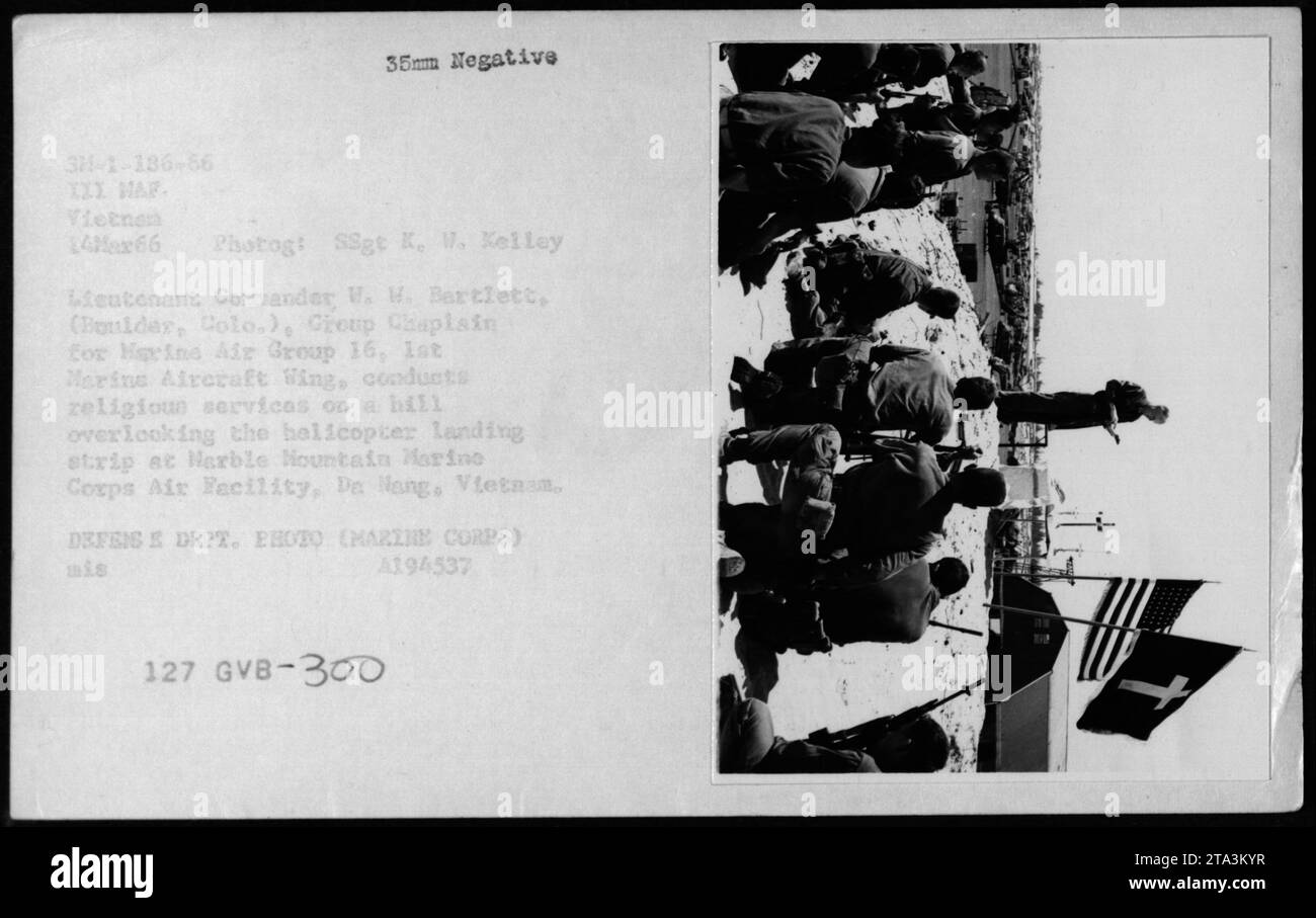 Comando tenente W.W. Bartlett, cappellano del gruppo Marine Air Group 16, conduce servizi religiosi su una collina vicino alla pista di atterraggio degli elicotteri presso la Marble Mountain Air Facility, da Nang, Vietnam, il 14 marzo 1966. Foto Stock