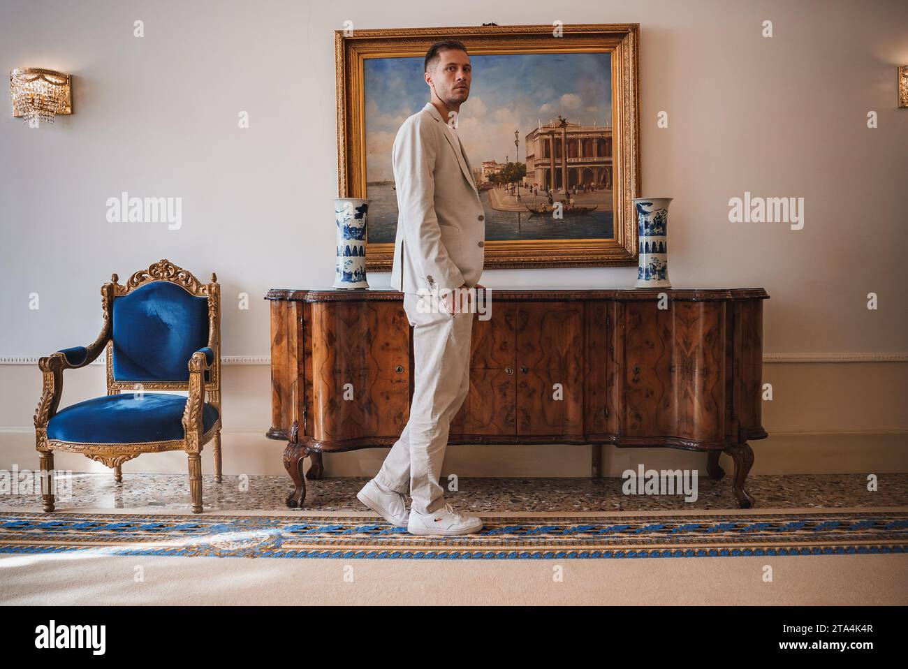 Uomo d'affari in elegante abito di fronte alla pittura veneziana Foto Stock