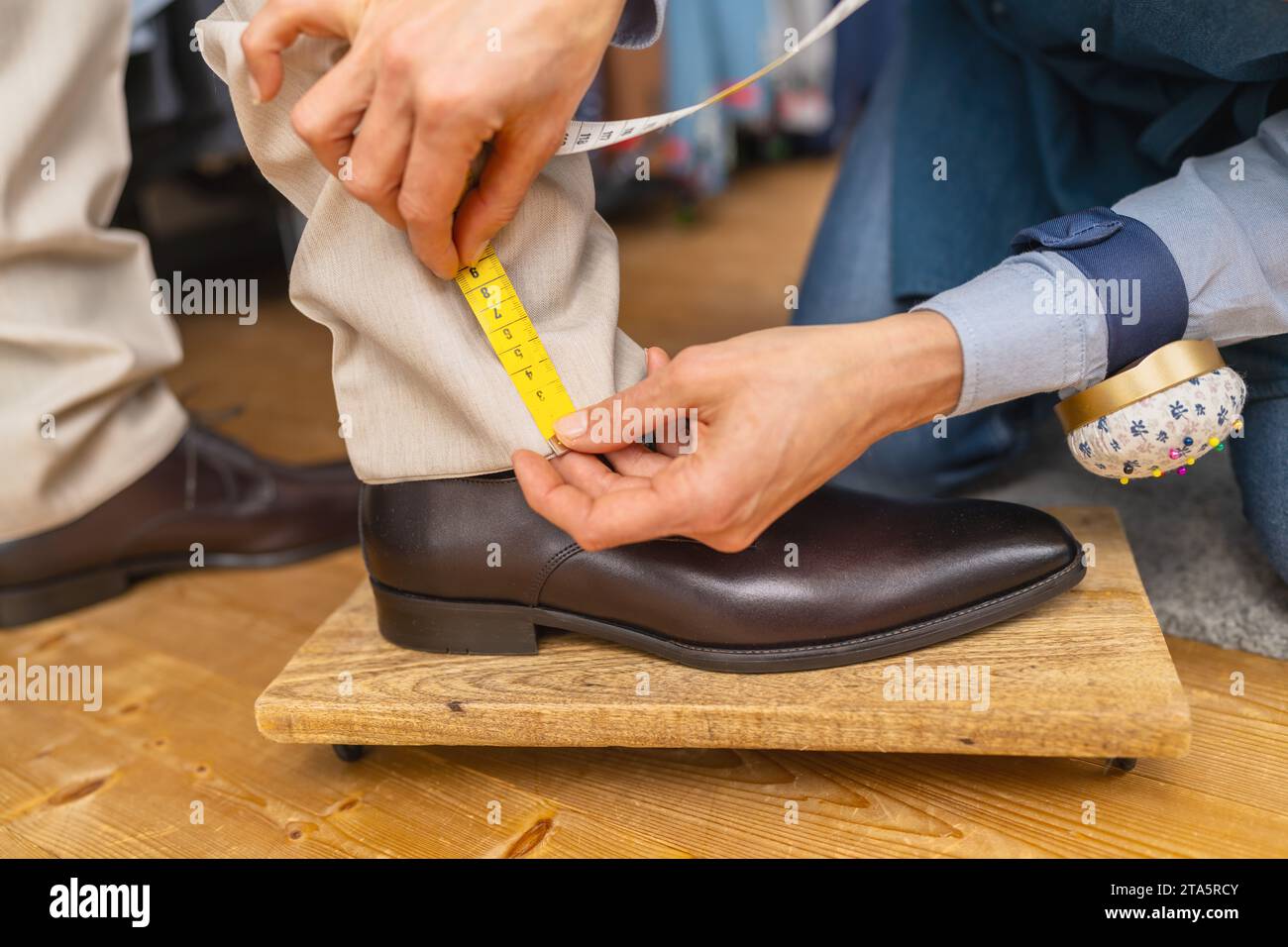 Lunghezza pantaloni graduati con nastro sulla caviglia dell'uomo sopra la scarpa marrone Foto Stock