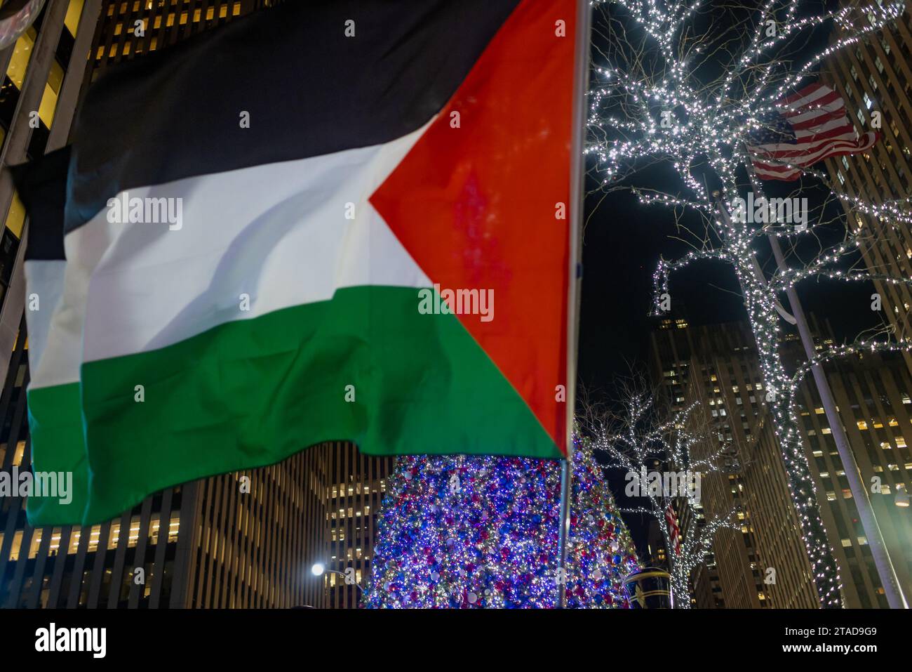 NEW YORK, NEW YORK - NOVEMBRE 29: I sostenitori della Palestina si riuniscono per una manifestazione presso l'edificio News Corp. Vicino all'illuminazione dell'albero Rockefeller il 29 novembre 2023 a New York. Il raduno arriva quando la tregua iniziale di quattro giorni tra Israele e Hamas è stata prolungata di due giorni fermando le sette settimane di guerra che ha ucciso migliaia di persone a Gaza a seguito dell'attacco di Hamas del 7 ottobre in Israele. (Foto di Michael Nigro/Sipa USA) Foto Stock