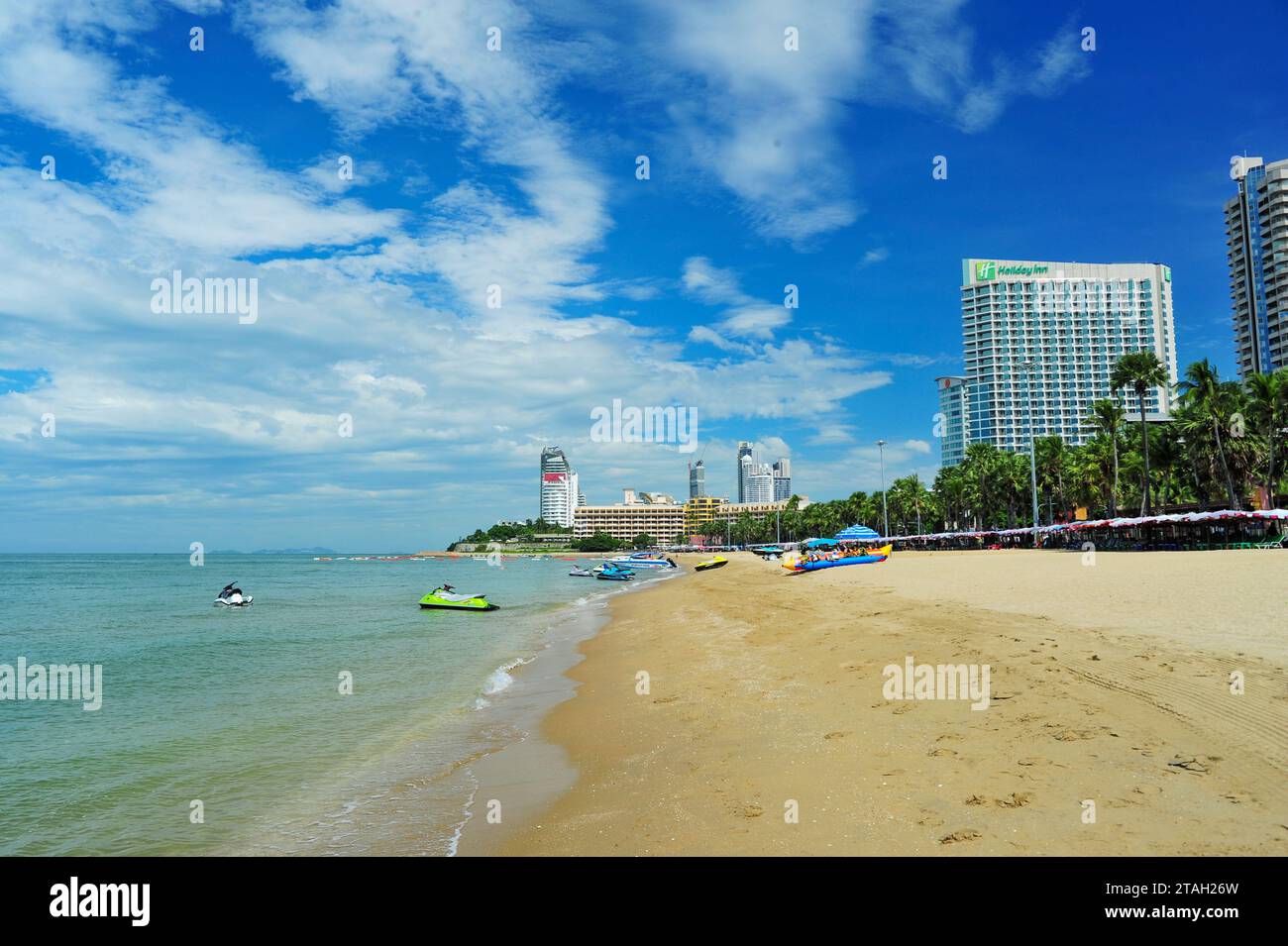 La spiaggia di Pattaya è lunga circa 3 chilometri. C'è una strada ombreggiata lungo la spiaggia. La spiaggia nord è un luogo tranquillo dove i turisti amano nuotare e rilassarsi. E' un centro di attivita' marine per coloro che vengono a riposarsi, come prendere il sole e sport acquatici. Il tratto lungo la spiaggia è pieno di hotel, ristoranti, negozi di souvenir e molto altro. Pataya, Thailandia. Foto Stock