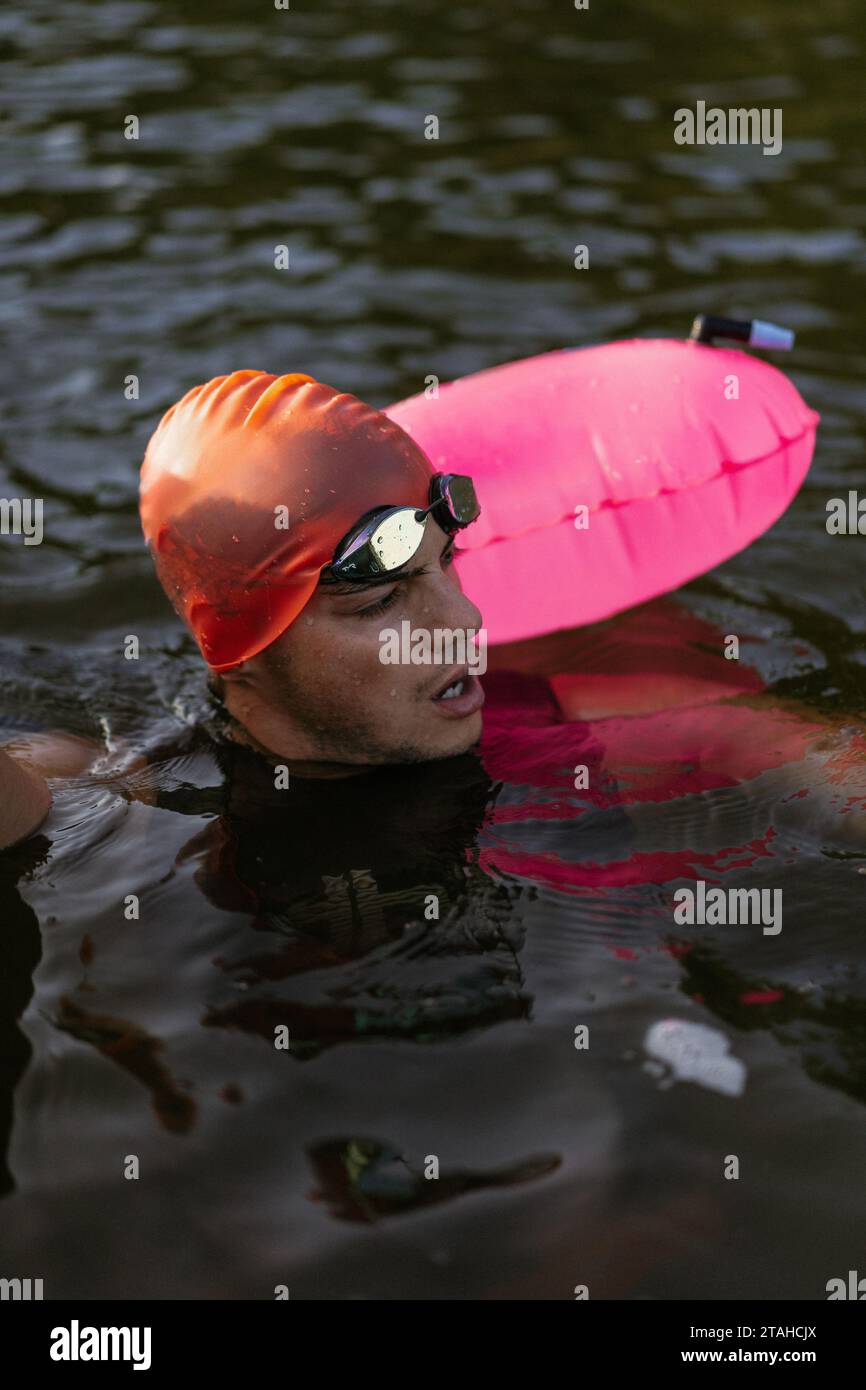 Nuotatore professionista in muta nuota in mare aperto su un lago. Foto Stock