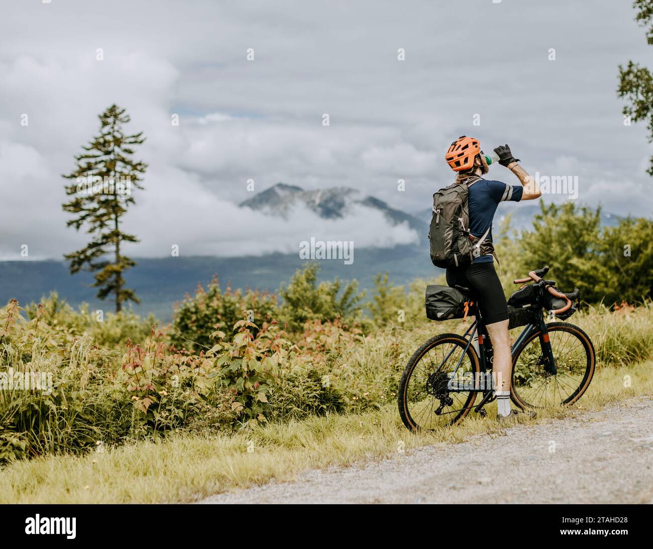 il ciclista fuoristrada si prende un drink d'acqua con katahdin sullo sfondo Foto Stock