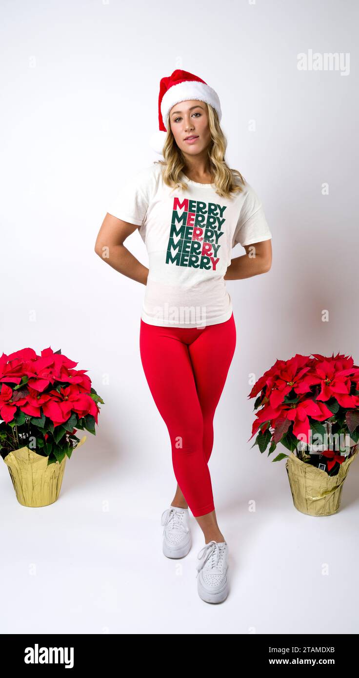 T-Shirt natalizia natalizia natalizia Santa Hat Leggings Red Bodybuilder femminile Foto Stock